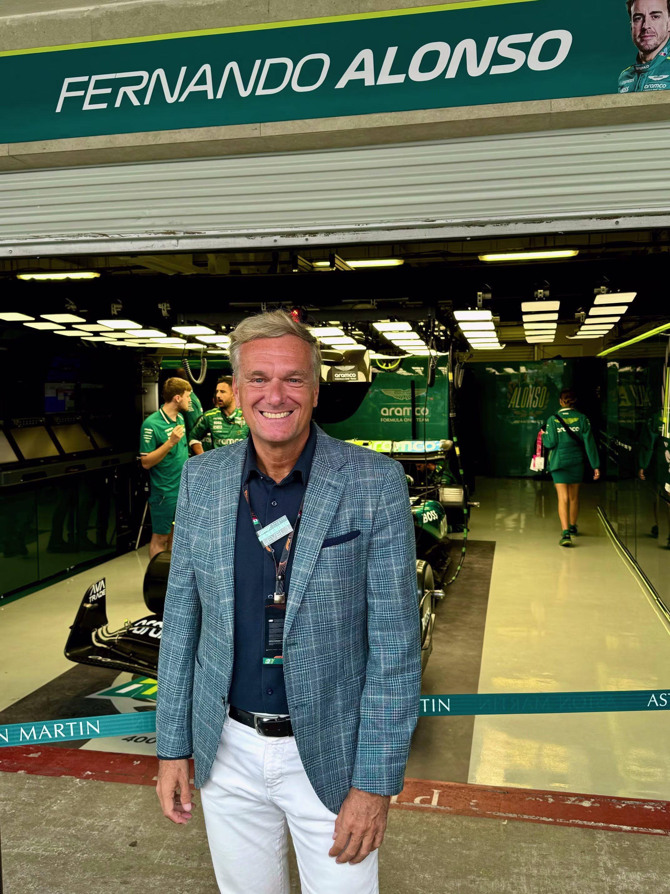 Stephan Born in front of a garage, showcasing a green and white sign above the entrance.