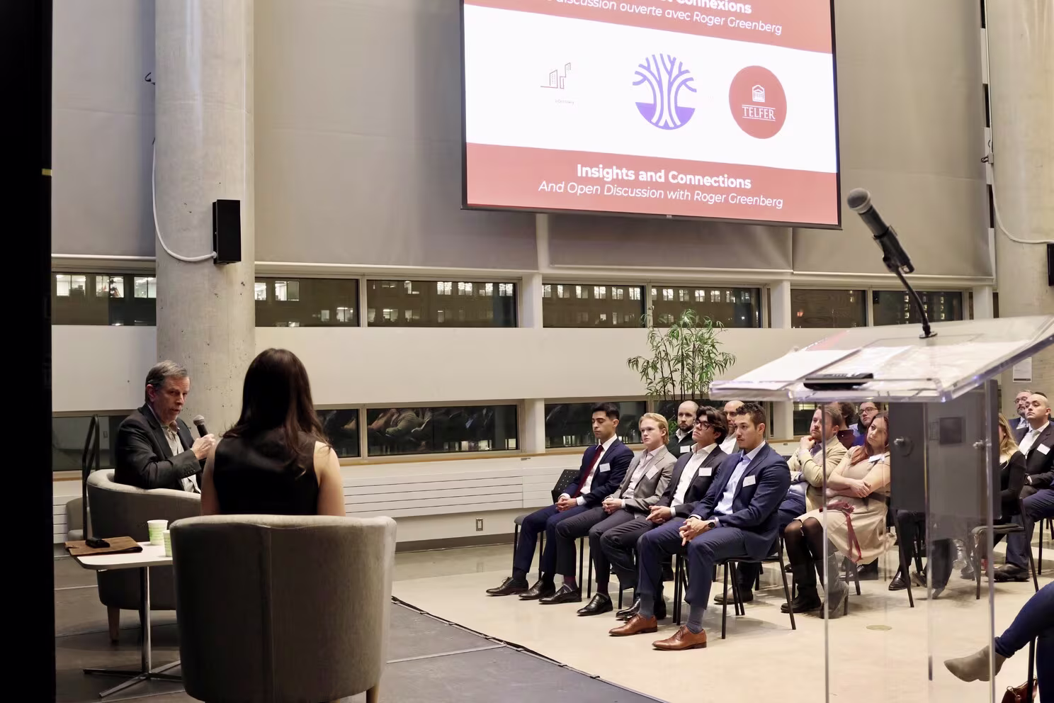 Roger Greenberg on stage with Telfer School of Management student Alexia Dumouchel. Photo by Caroline Phillips.