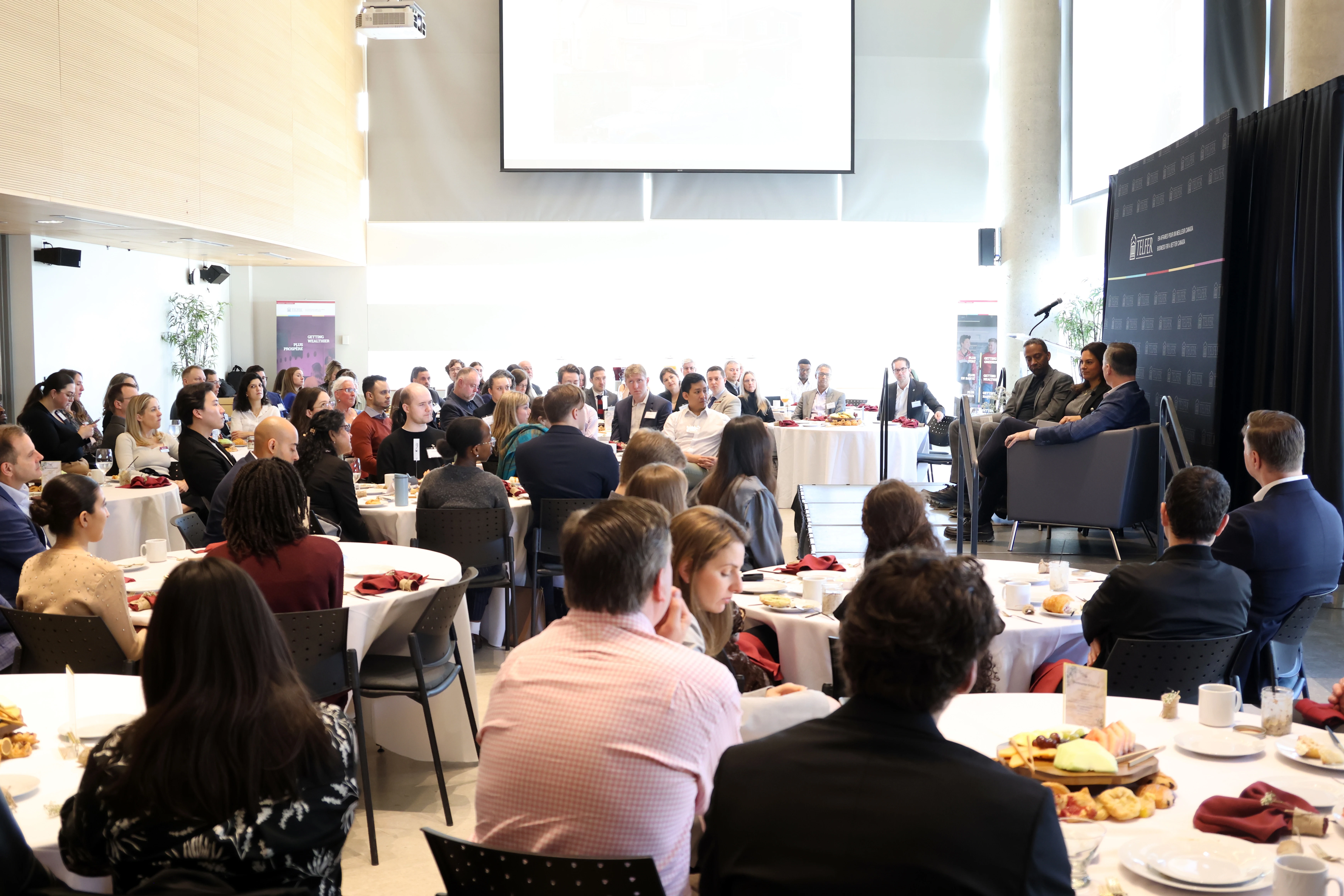 A group of people sitting at tables during the CEO of The Year Breakfast.