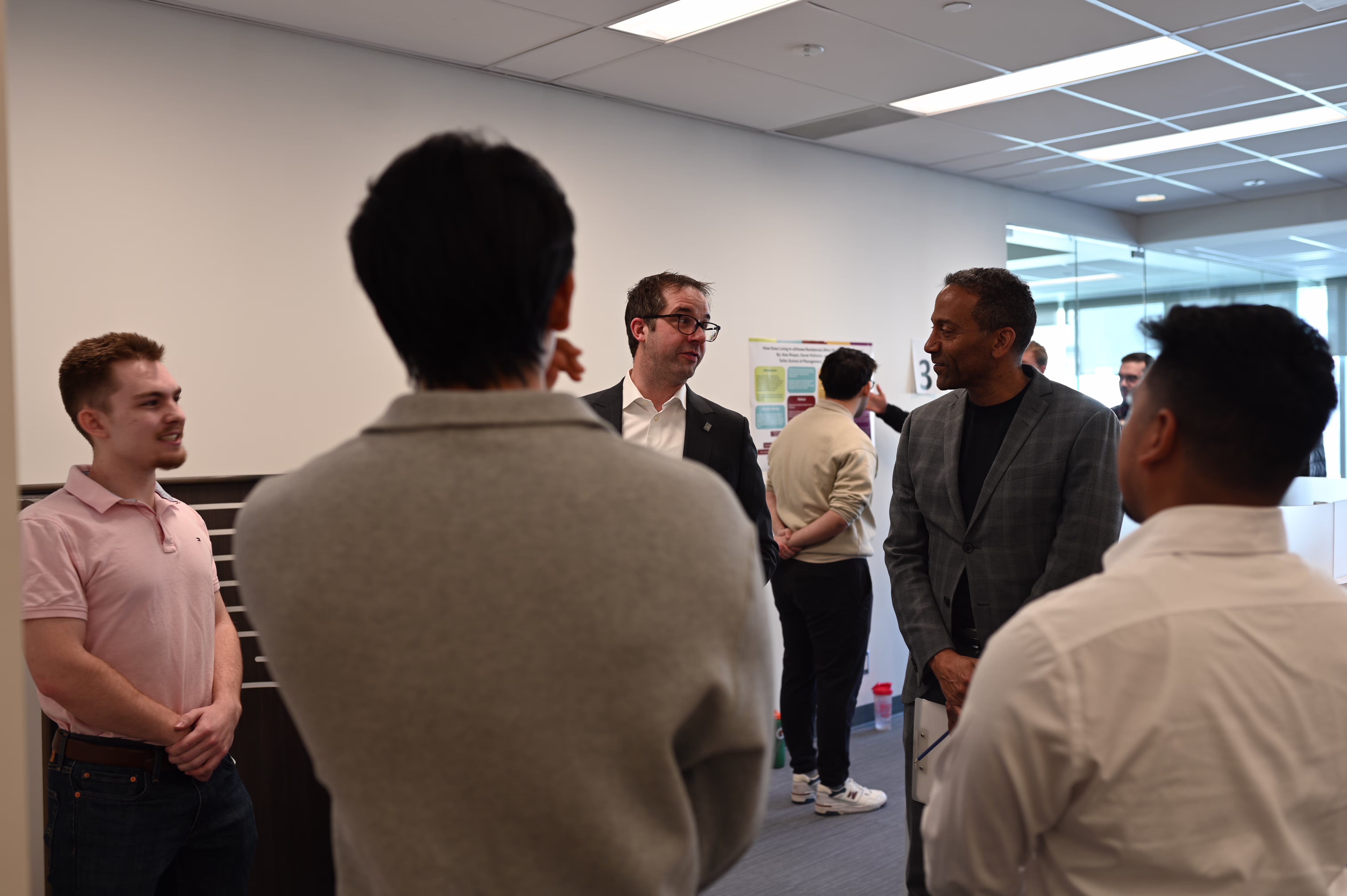 A student explains his project to a professor during the showcase session