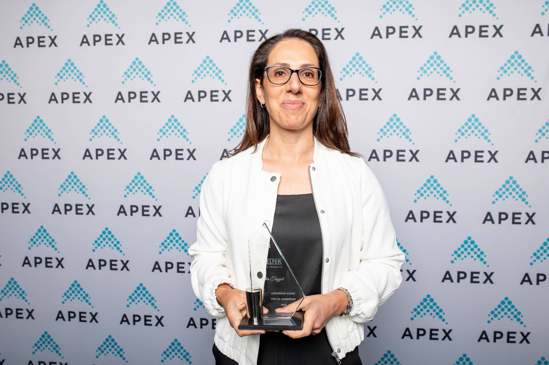 Alia Tayyeb holds her award for the 2025 APEX (Association of Professional Executives of the Public Service of Canada) Leadership Award at the Awards of Excellence Ceremony.