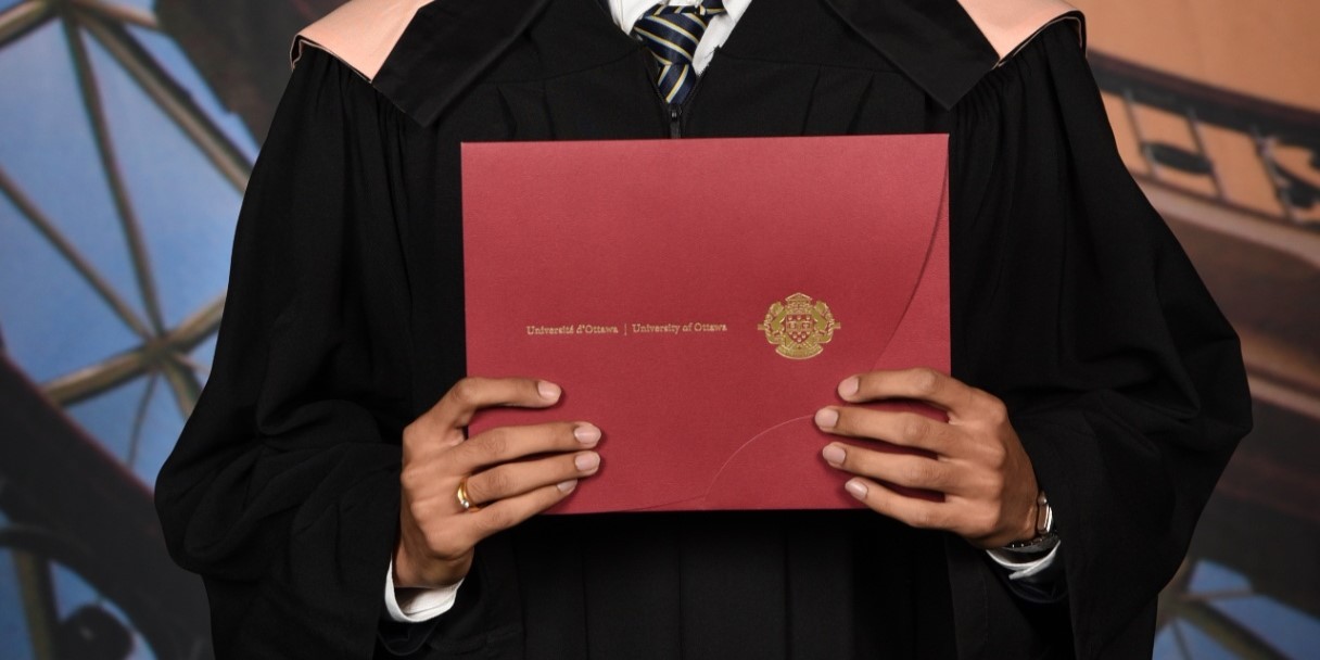 Dipen holding his diploma