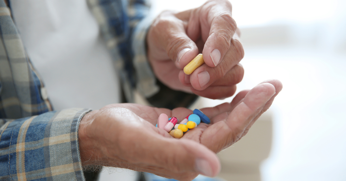 elderly person taking pills