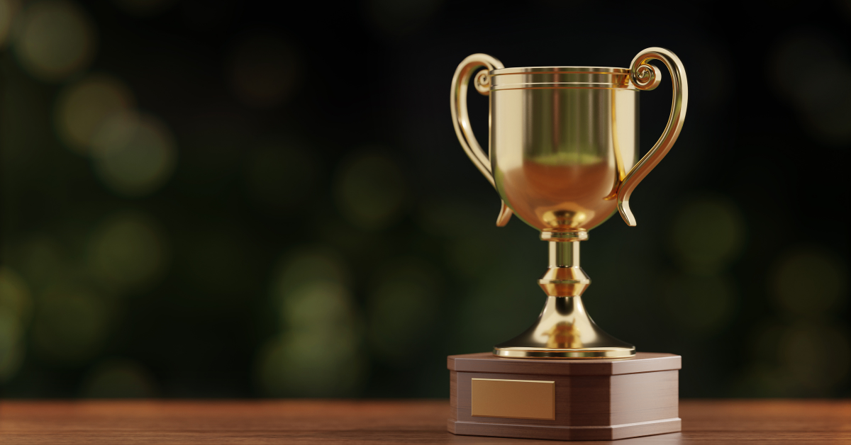 Golden trophy on brown wooden table