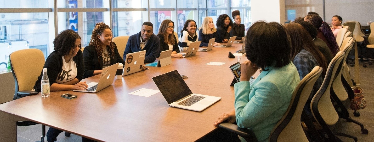 individuals of different cultures sitting around a board room table