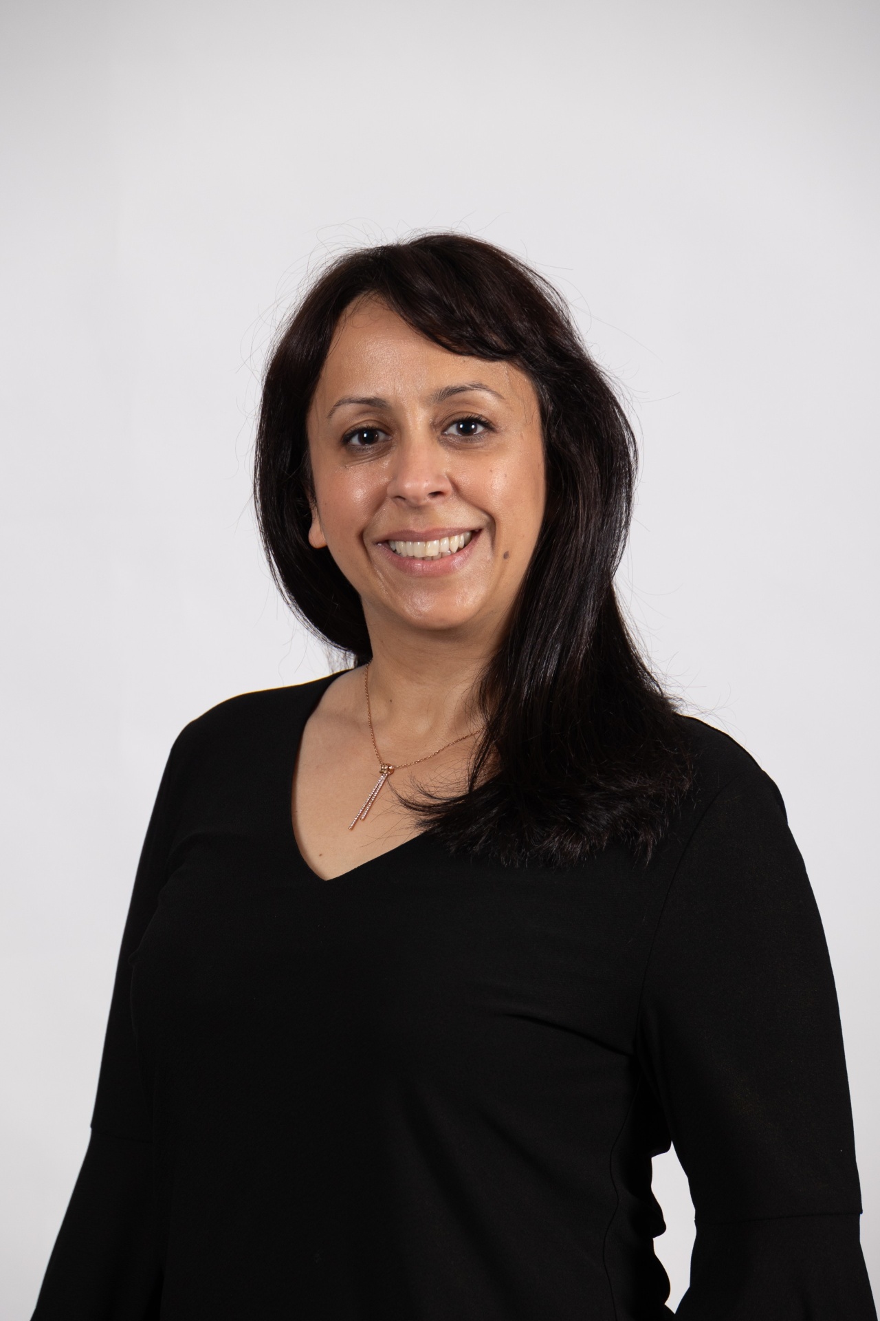Manal in front of a white background.