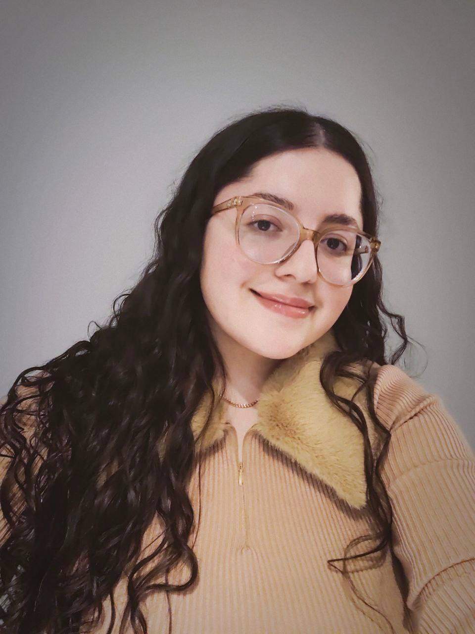 Shay in front of a grey background.