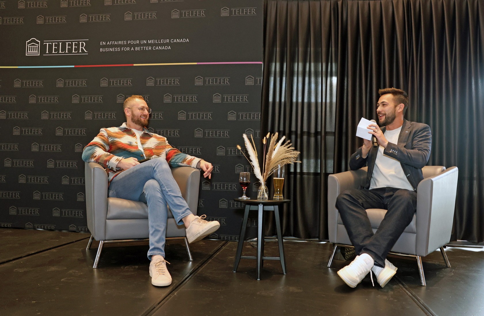 Fullscript CEO Kyle Braatz (left) and Shopify VP Brennan Loh (right) sitting on stage at the 