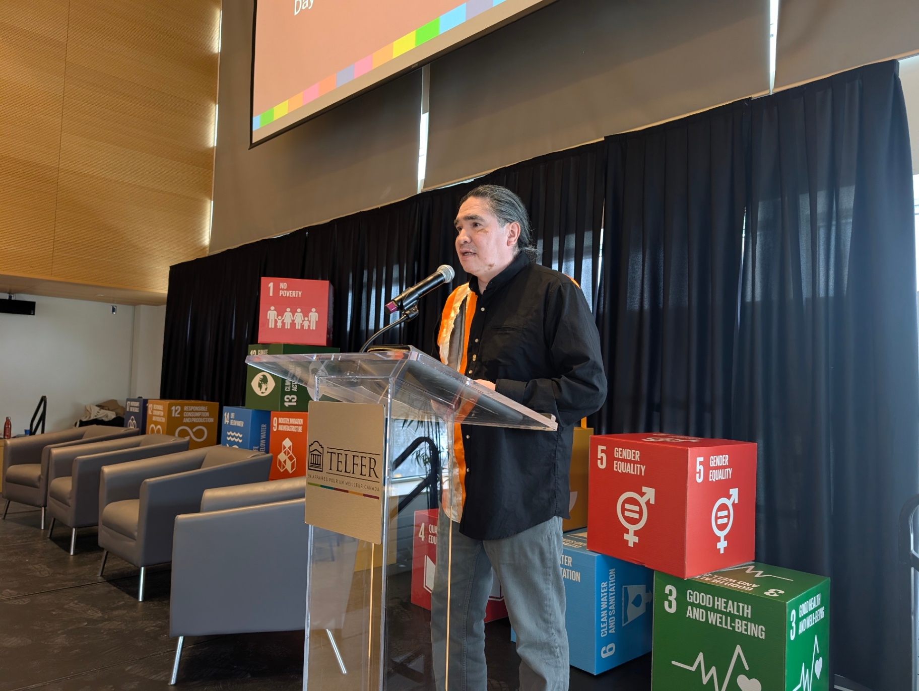 Speaker presenting at a podium during the Innovation Sprint event.