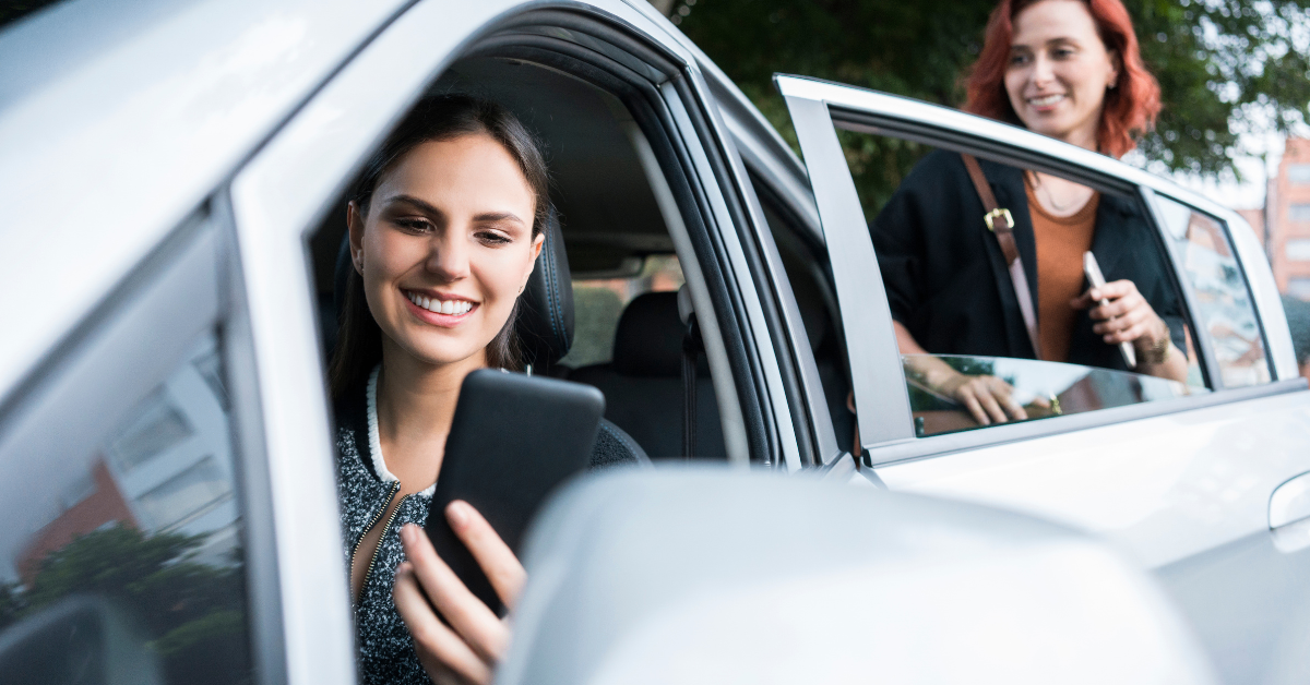 woman driving an uber car with a female passenger