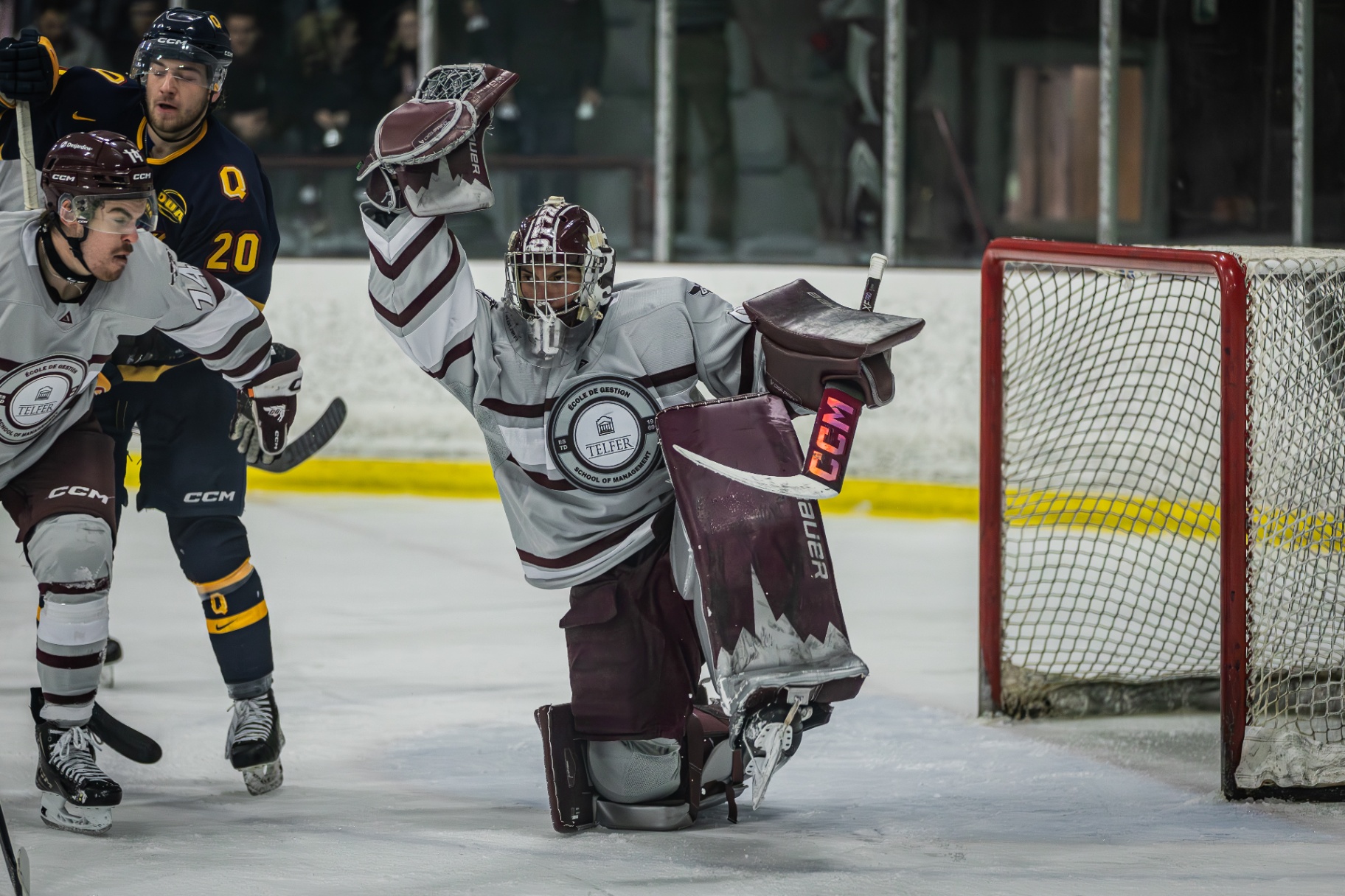Franky Lapenna crouches in front of the net with his glove raised to block a shot.