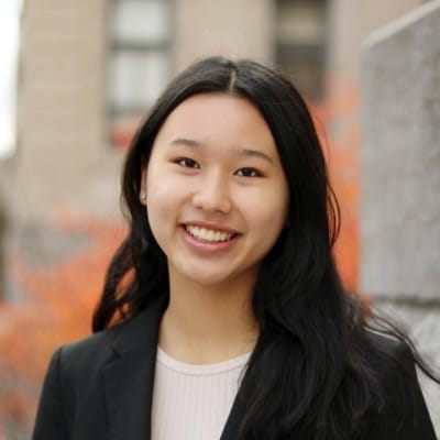 Megan Thompson, valedictorian and Bachelor of Commerce graduate in Marketing, smiling outdoors in a professional portrait.