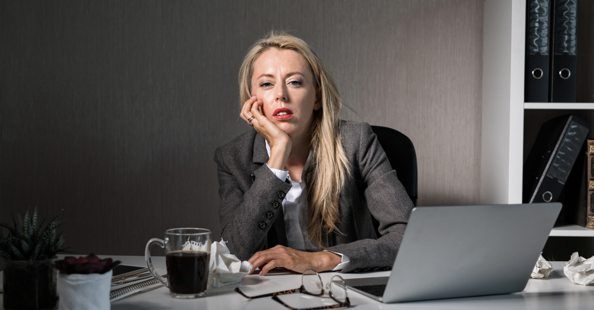 woman at a desk with a tired look wondering if her work is pointless