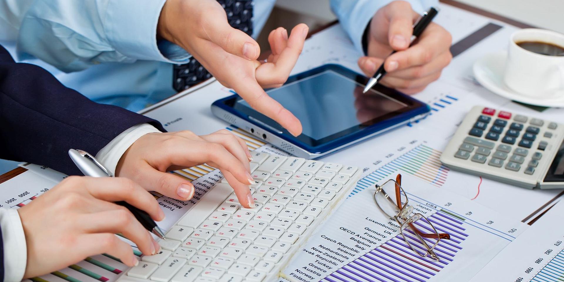 2 people using a tablet and a keyboard