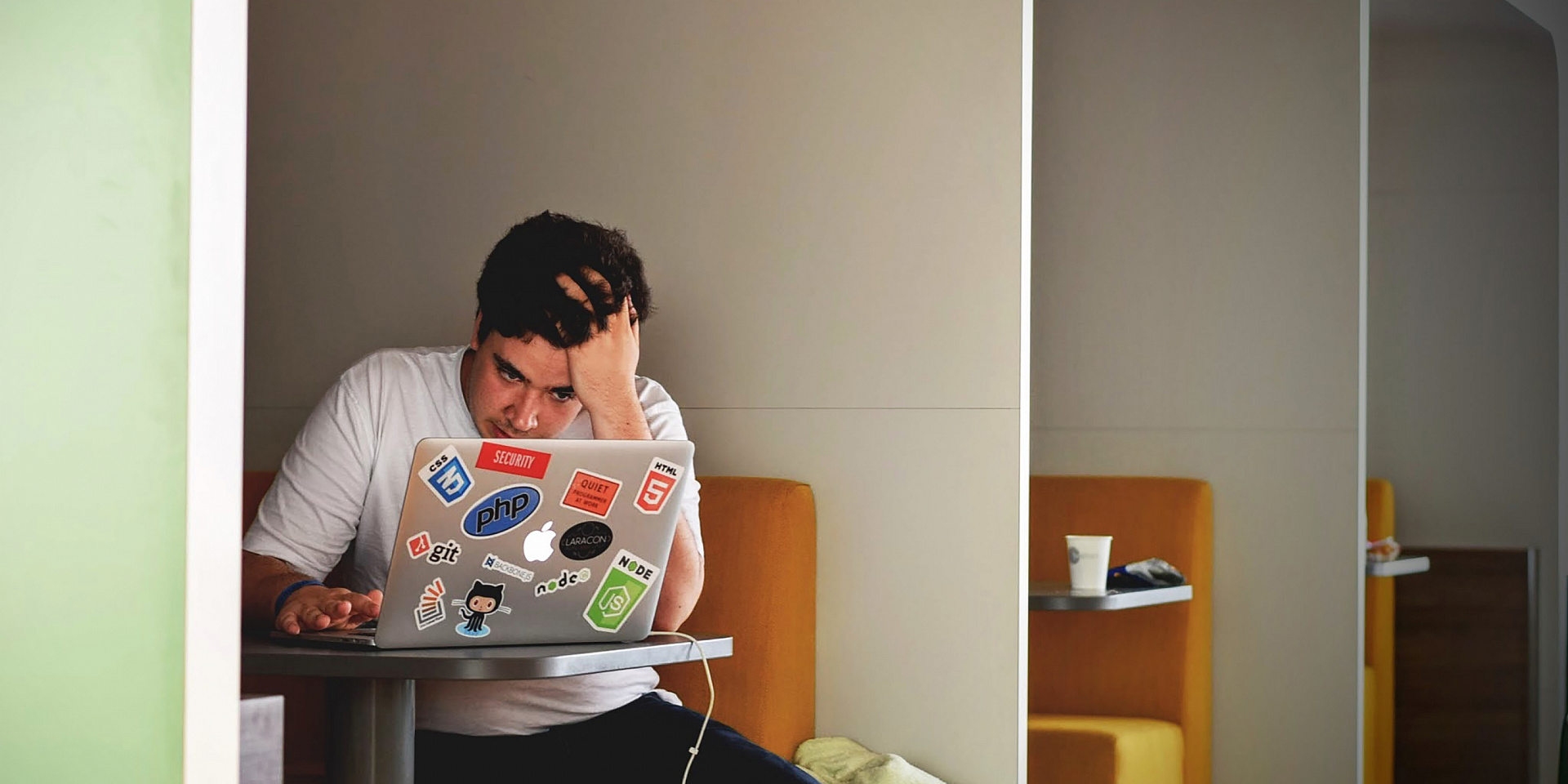 stressed student holding his head in a study area