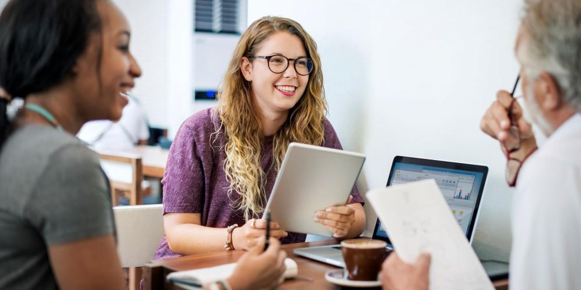 Woman smiling at her co-workers