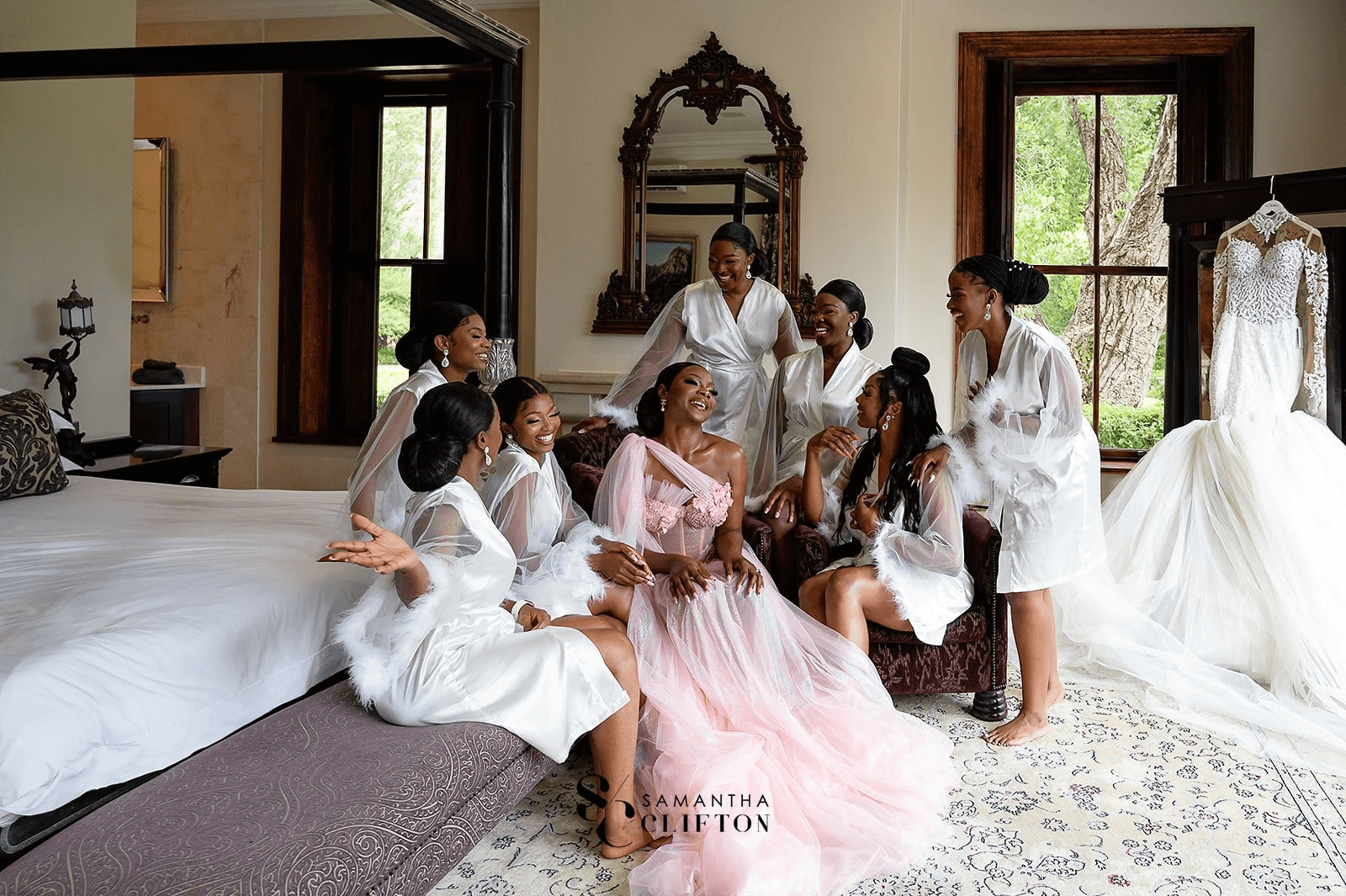 A bride wearing a Zoba Martin wedding gown with her bridesmaids.
