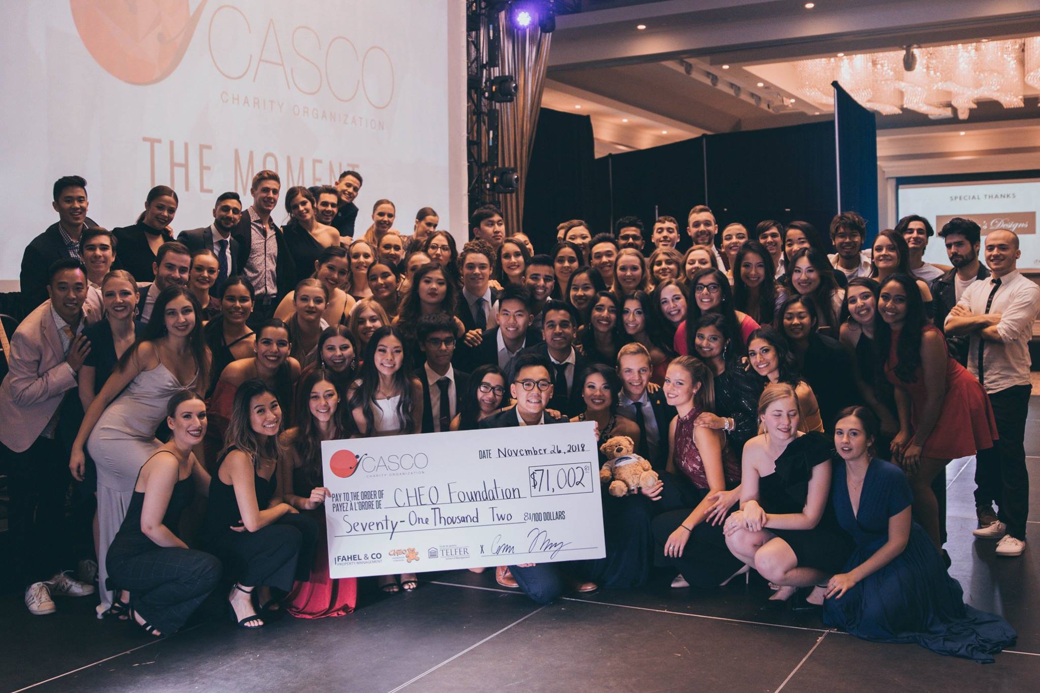 A group of Casco members celebrating a cheque