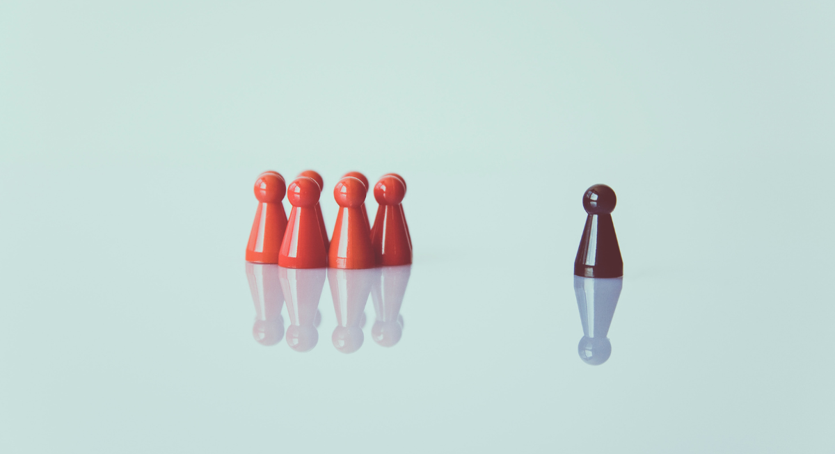 A group of game pieces together and one standing alone