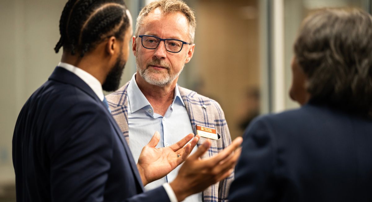 A man (Glen Orsak) is in conversation with another man at the Telfer Centre for Executive Leadership.