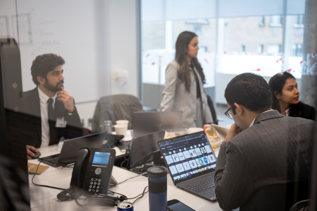A team of Telfer students preparing their solution at a business case competition.