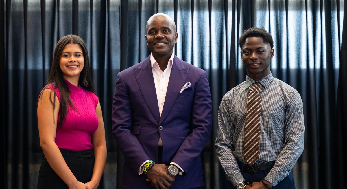 Abigail Fabian Gonzalez and Louis Philippe Ariel Nanihio standing next to Wes Hall