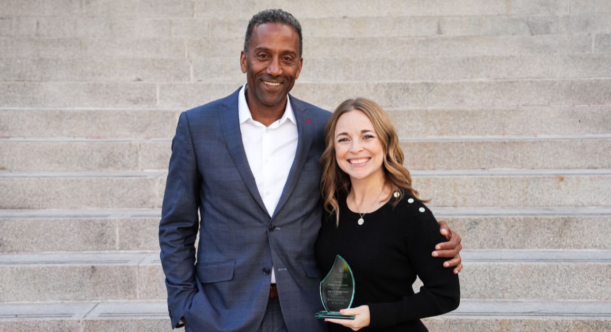 Amanda Richardson holding her award beside Dean Brutus