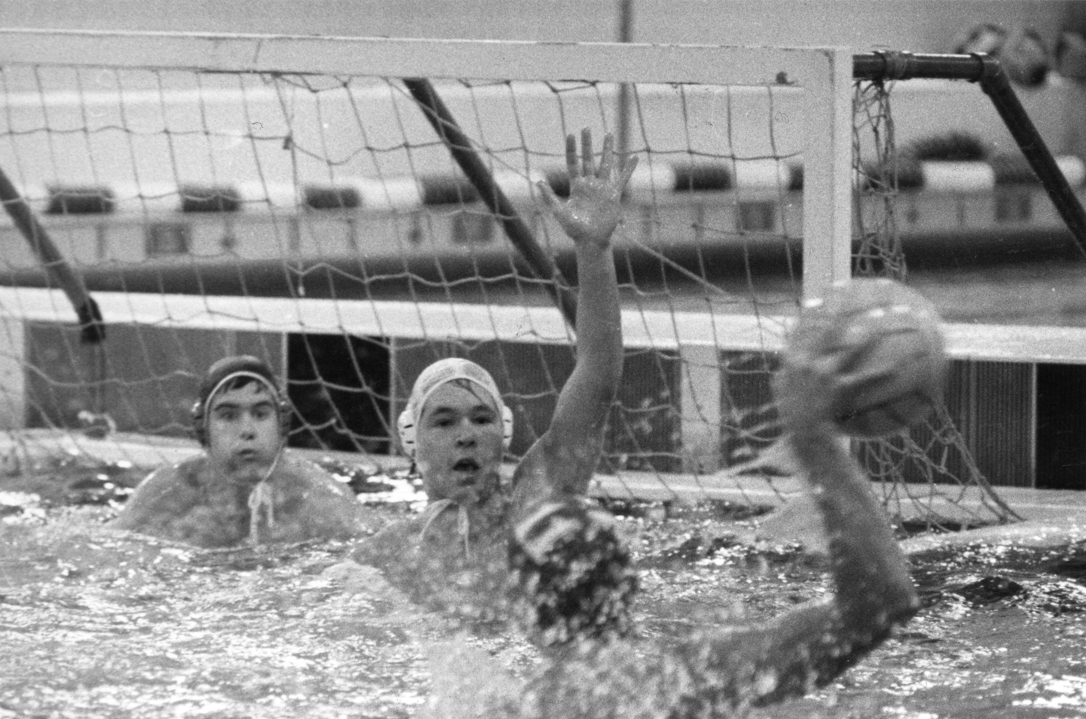 Black and white image of Myron Tetreault and teammates playing water polo in the water.