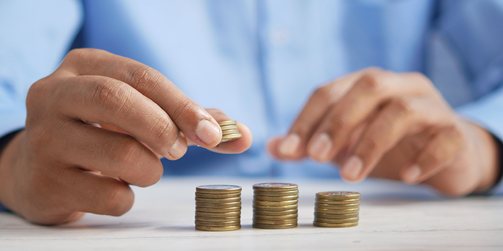 Business Man sitting stacking coins