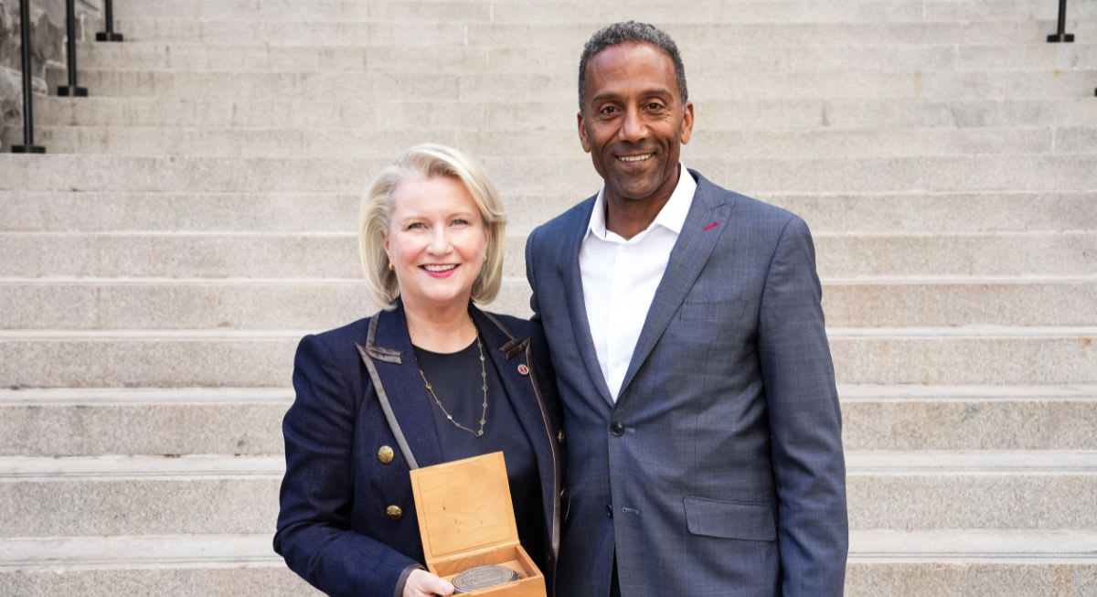 Christine Kincaid holding the R. Trudeau Medal beside Dean Brutus