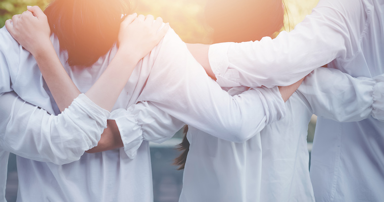 Connected family business members hugging