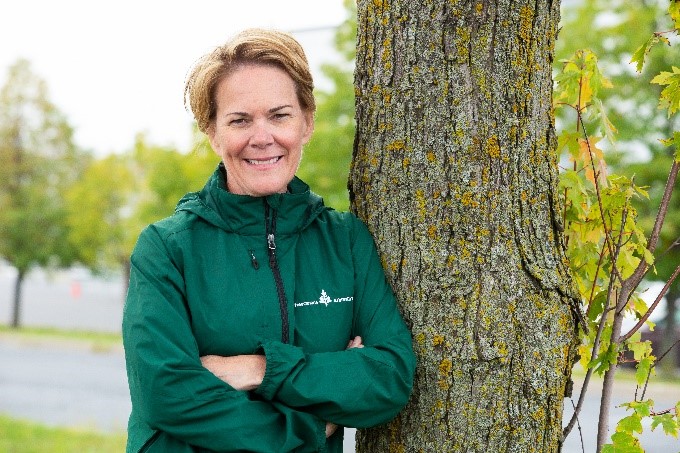 Danielle St-Aubin, Telfer Executive MBA Graduate 2014 and Former CEO of Tree Canada standing by a tree