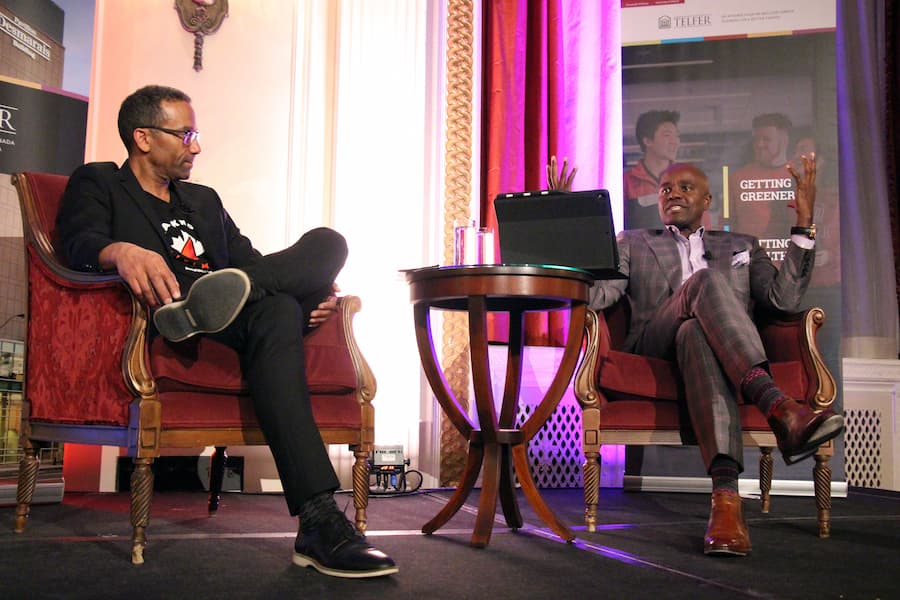 Dean Brutus and Wes Hall sitting on stage