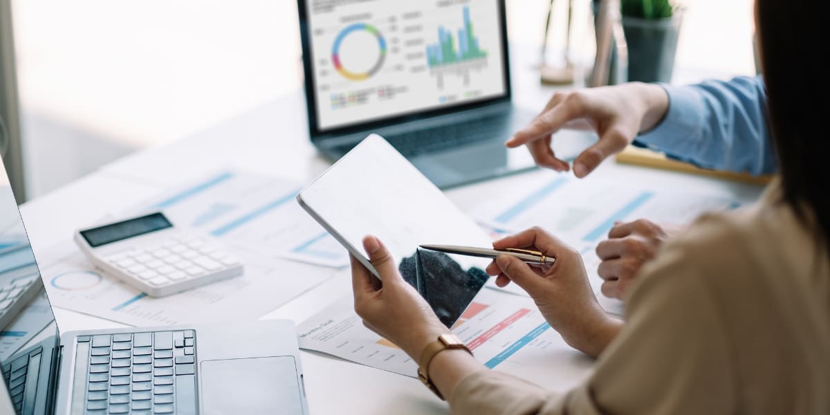 Two people discuss the data represented in a graph