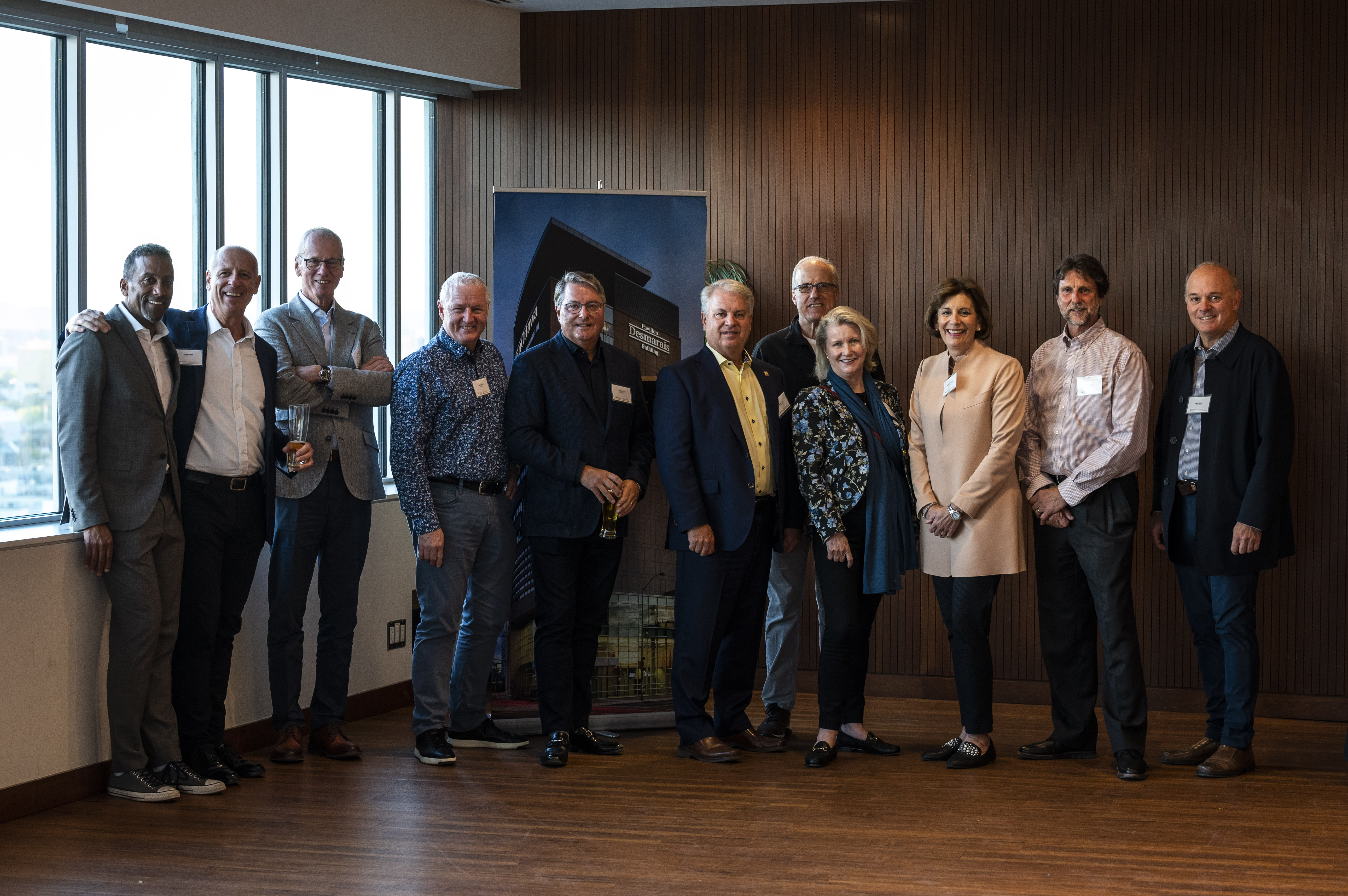 A group of people, including Christine Kincaid, posing inside the Desmarais Building.