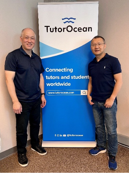 Founders of TutorOcean next to a banner advertising their platform