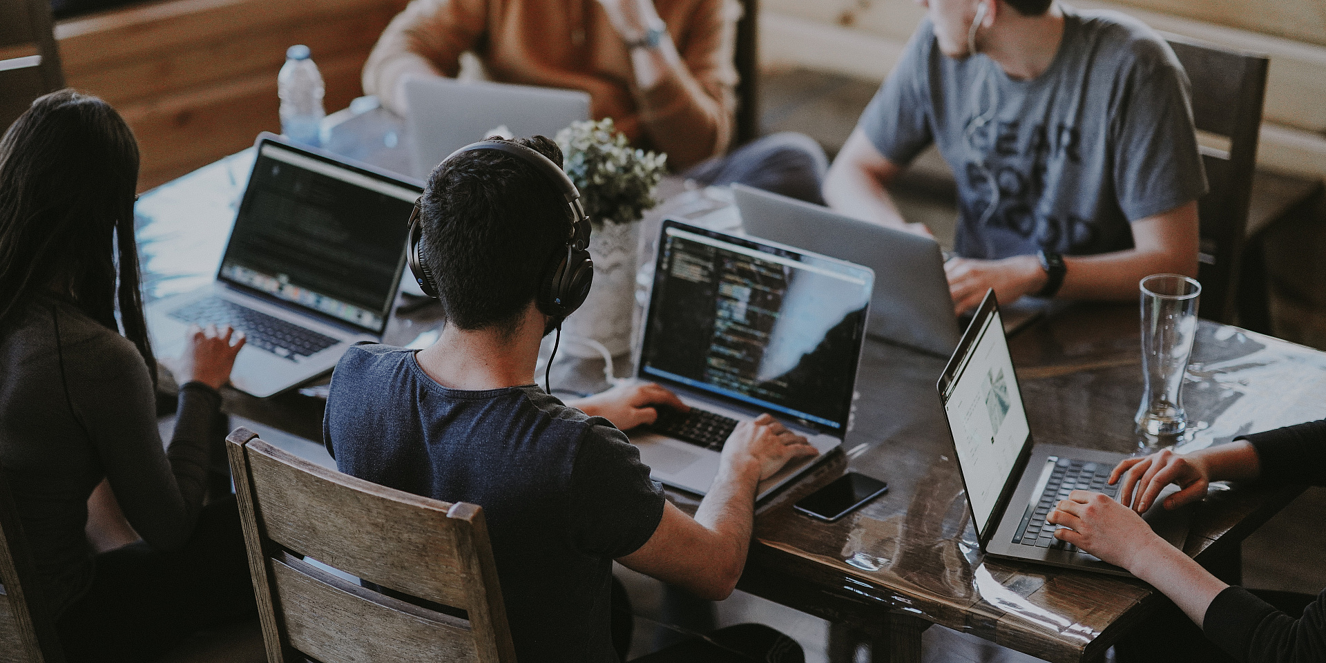 Group of people working together on laptops