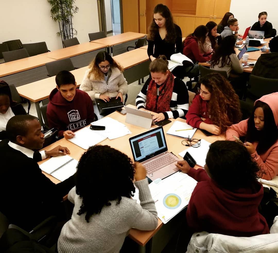 Group of Telfer students working around a table with laptops