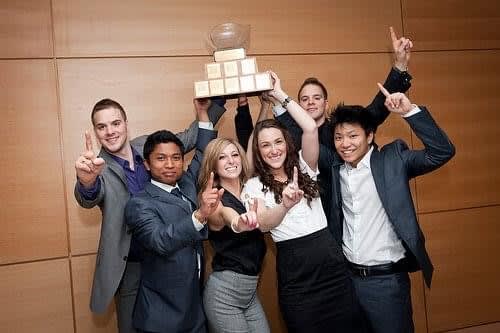 Micheal and Chris Weatherhead with their team proudly posing with a trophy.