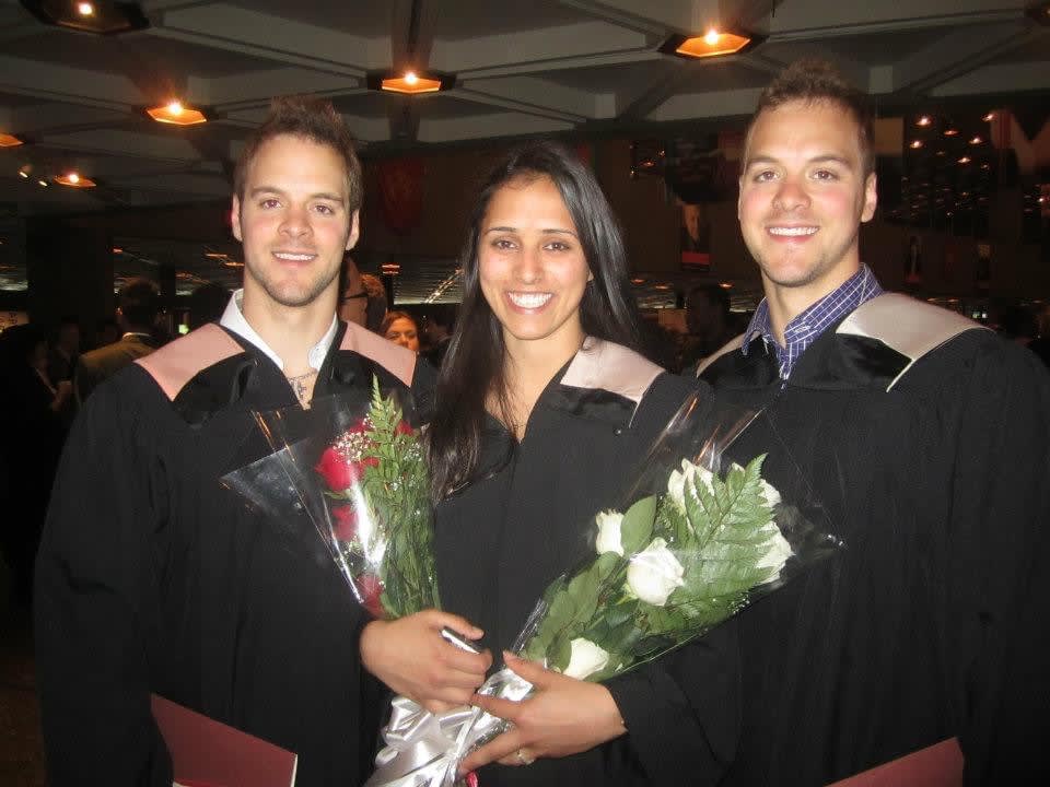 Micheal, Chris Weatherhead, and a friend pose with their diplomas at graduation.