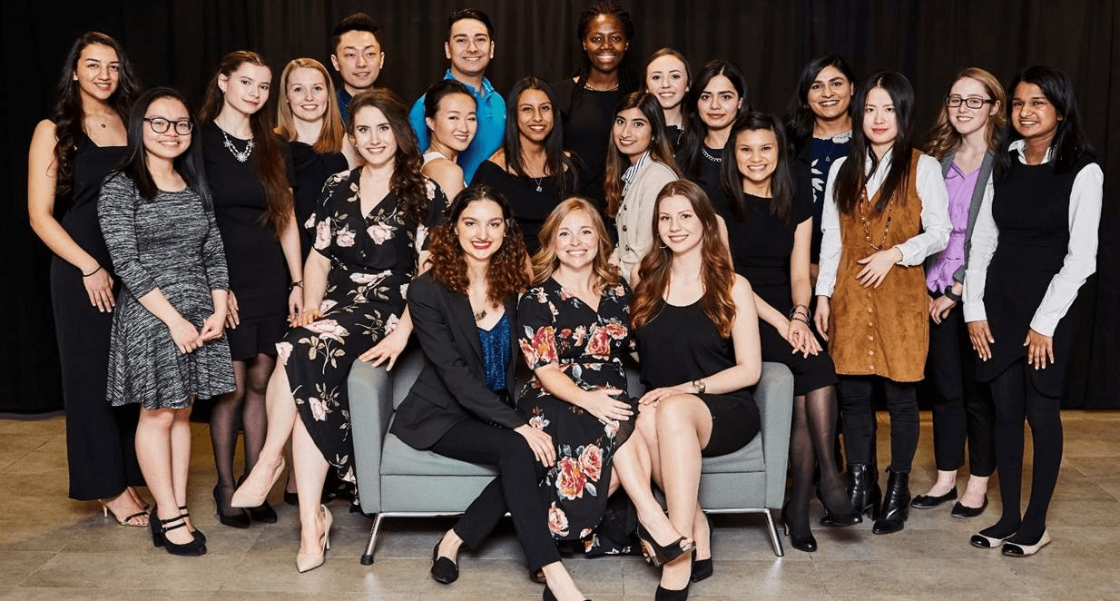 Amanda Richardson posing with a group of students at an event.