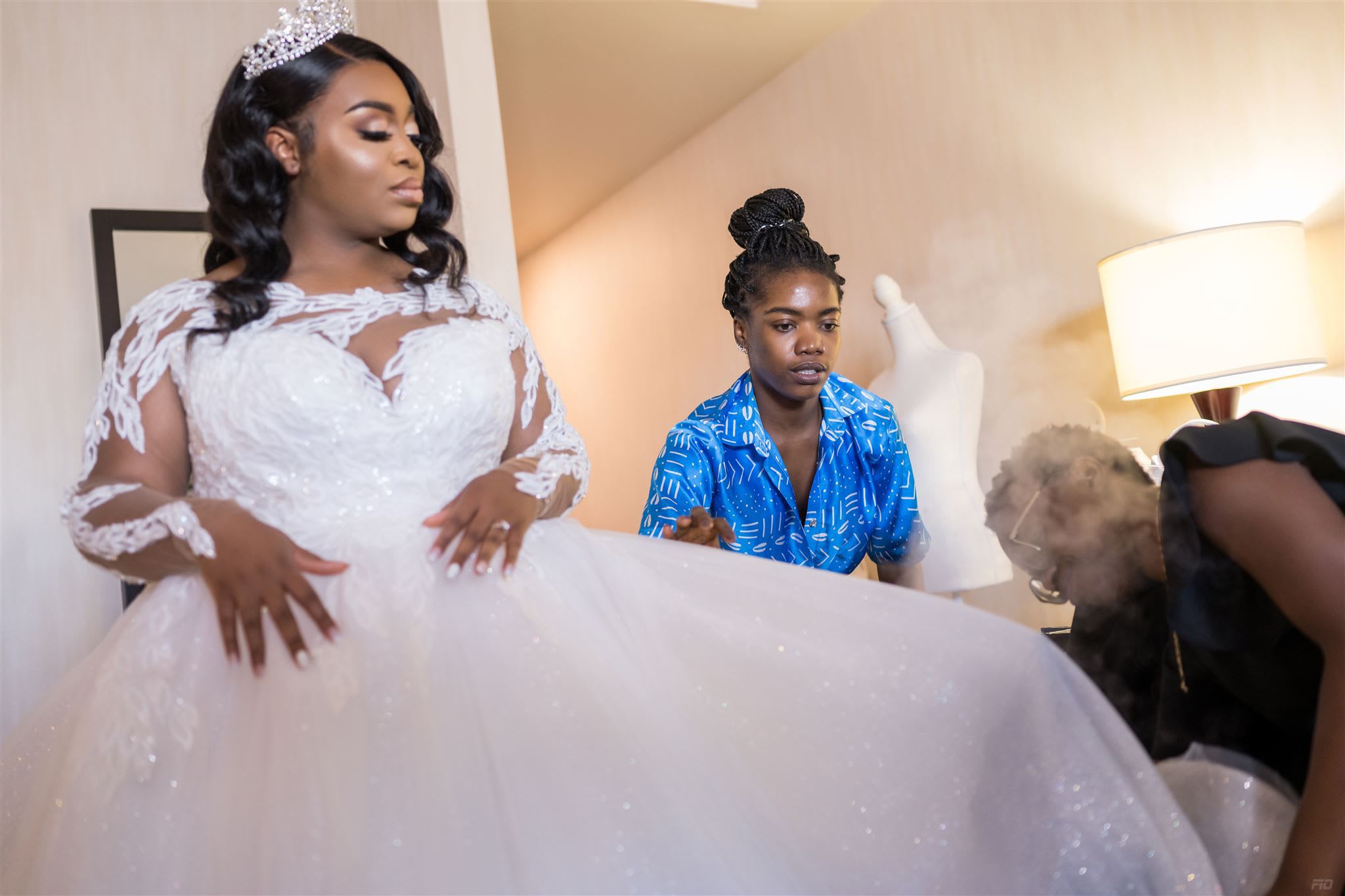 Chizoba Martin helps a bride with her wedding dress.