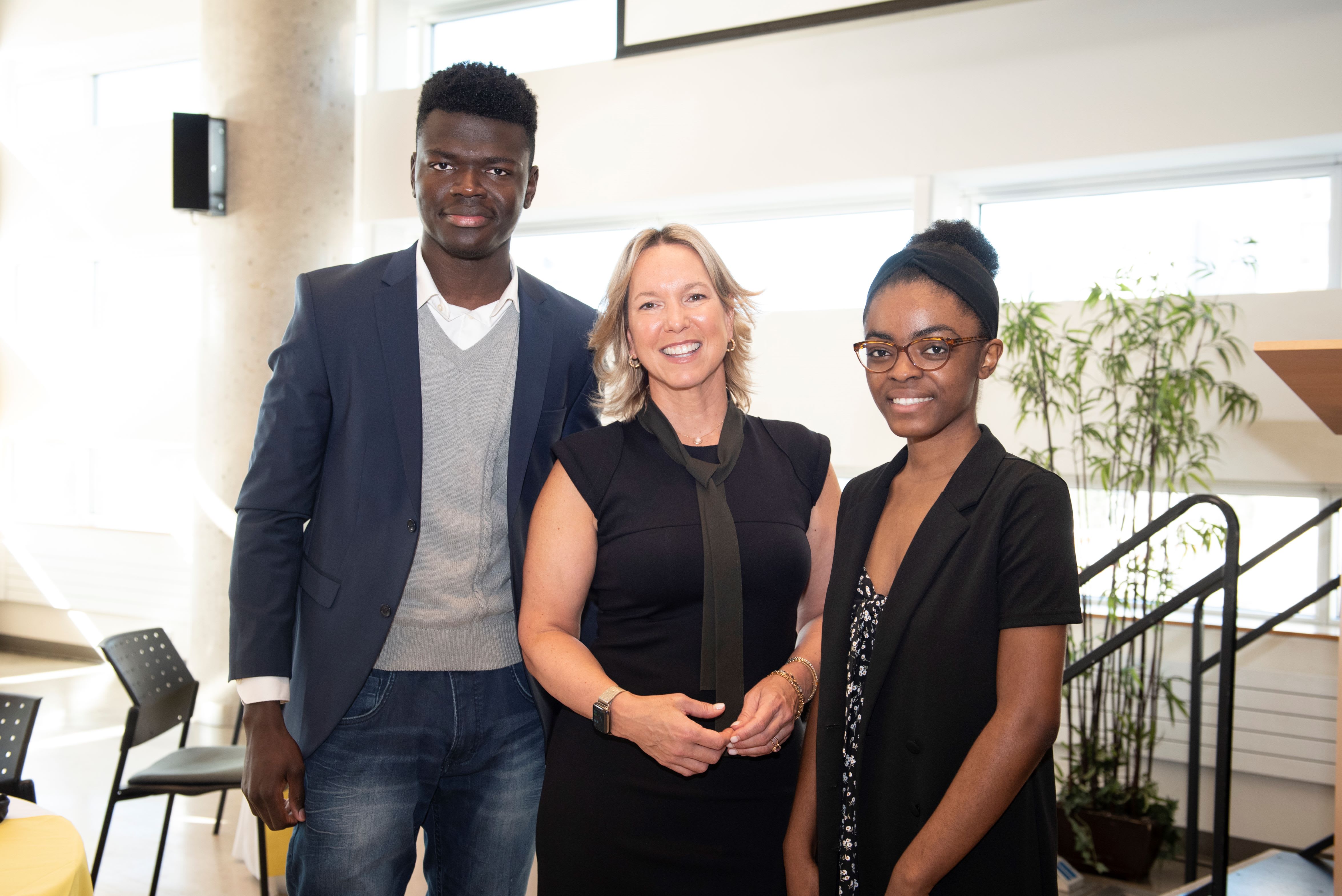 Kathryn Tremblay posing with two students