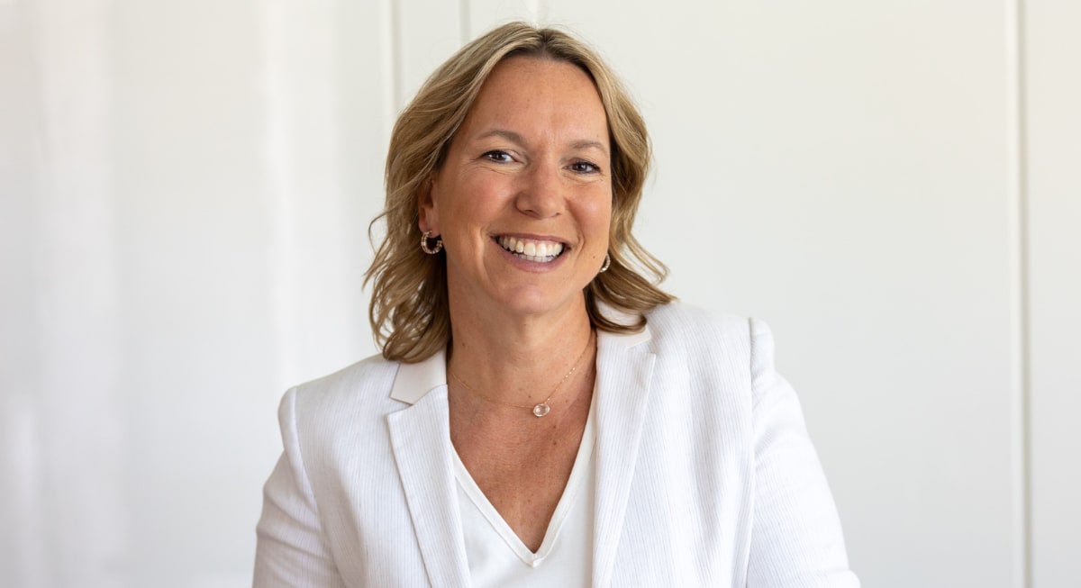 Kathryn Tremblay smiling wearing a white suit