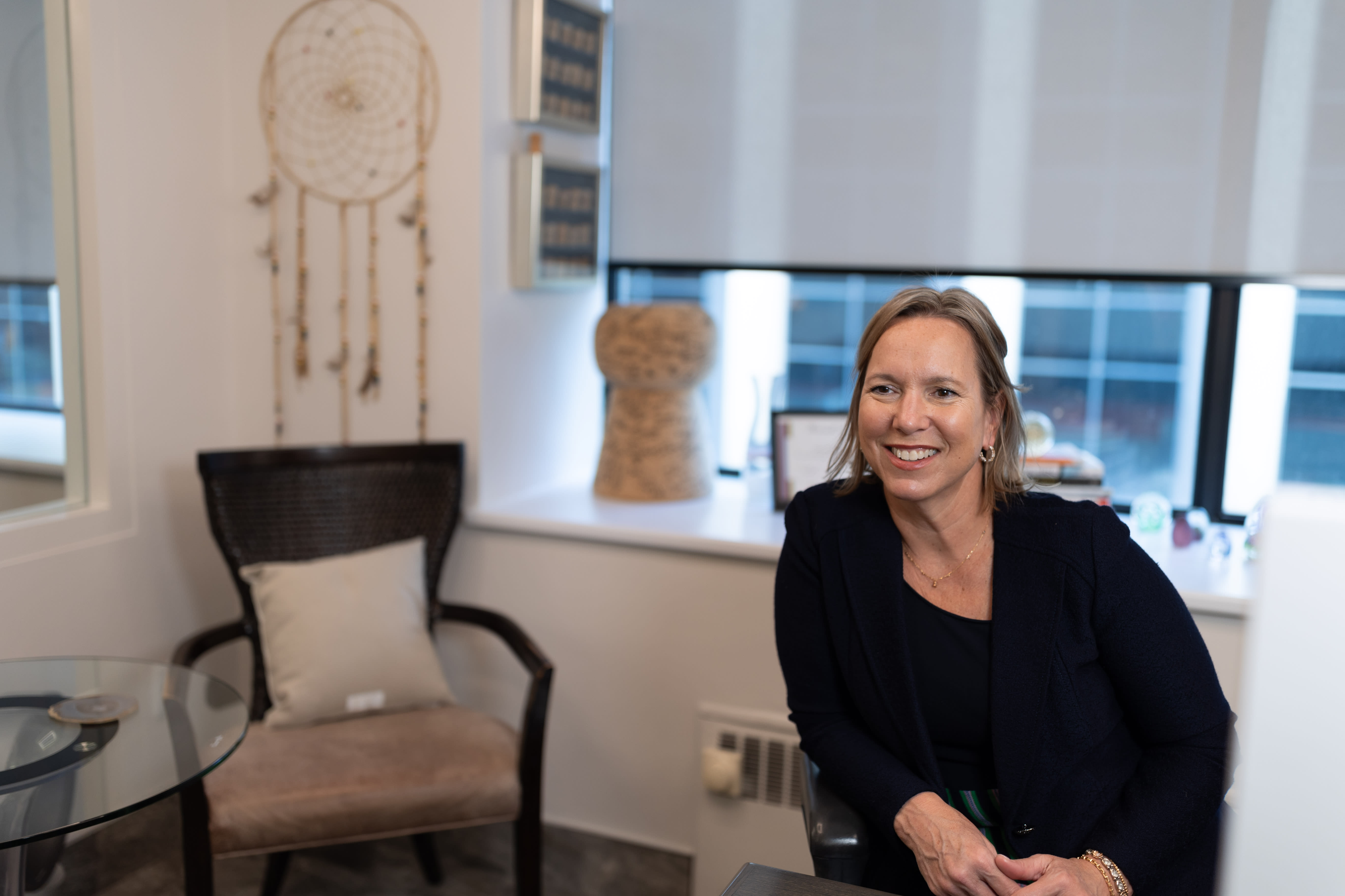Kathryn Tremblay sitting in an office wearing a black suit