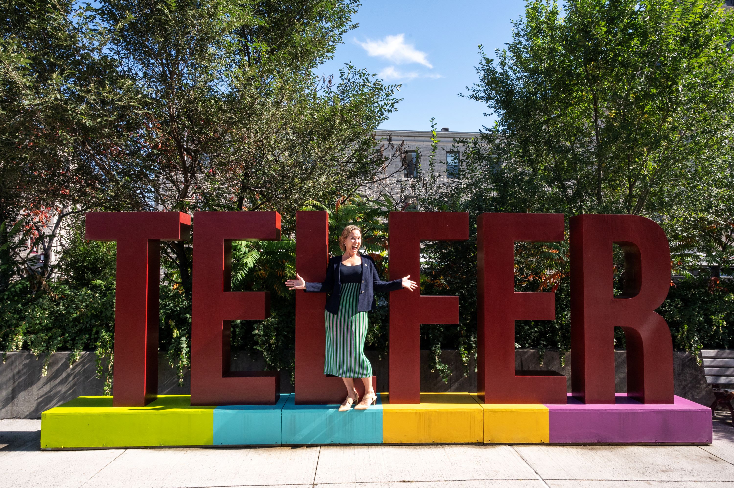 Kathryn Tremblay posing in front of the Telfer letters
