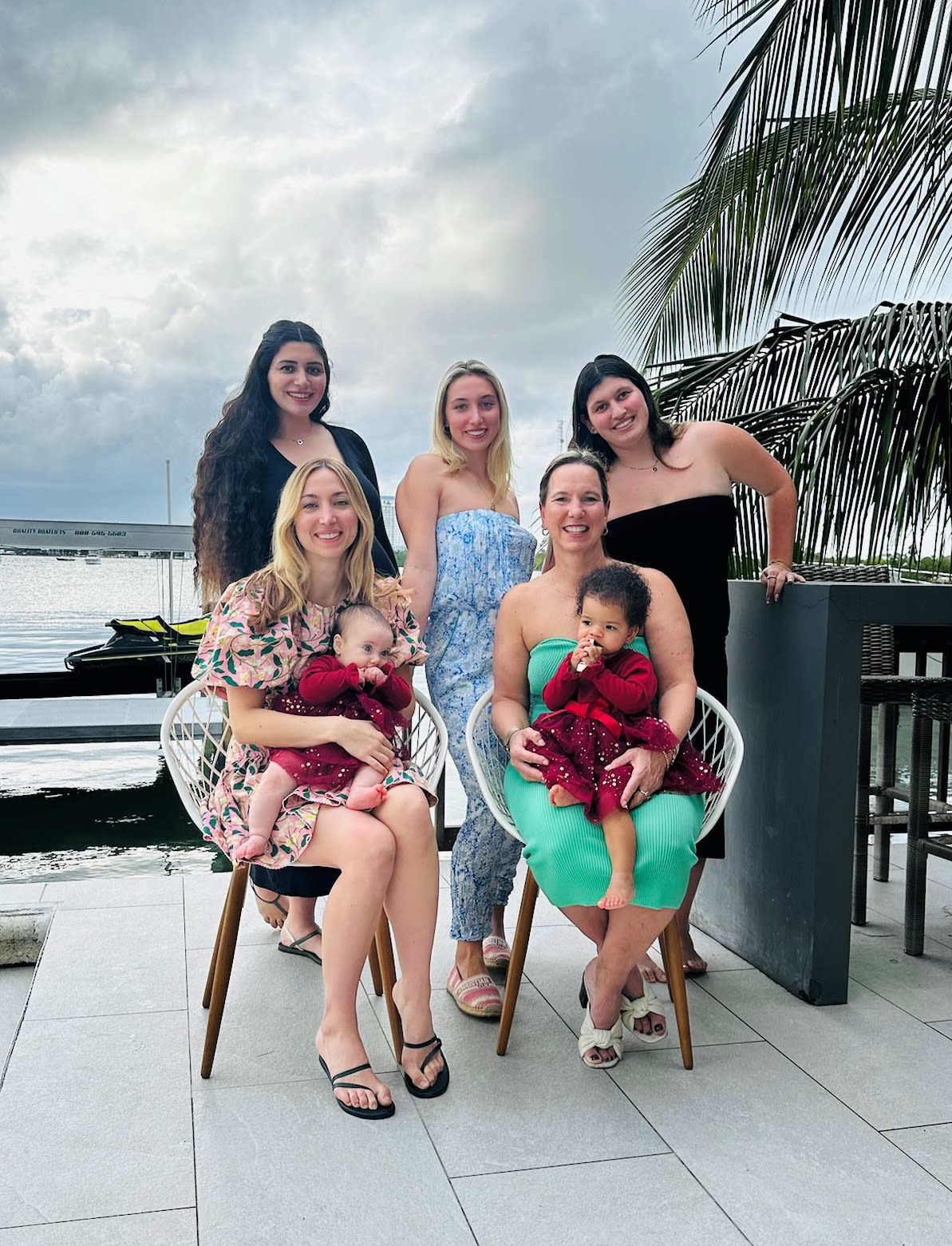 Kathryn Tremblay sitting posing with her four daughters and grandchildren