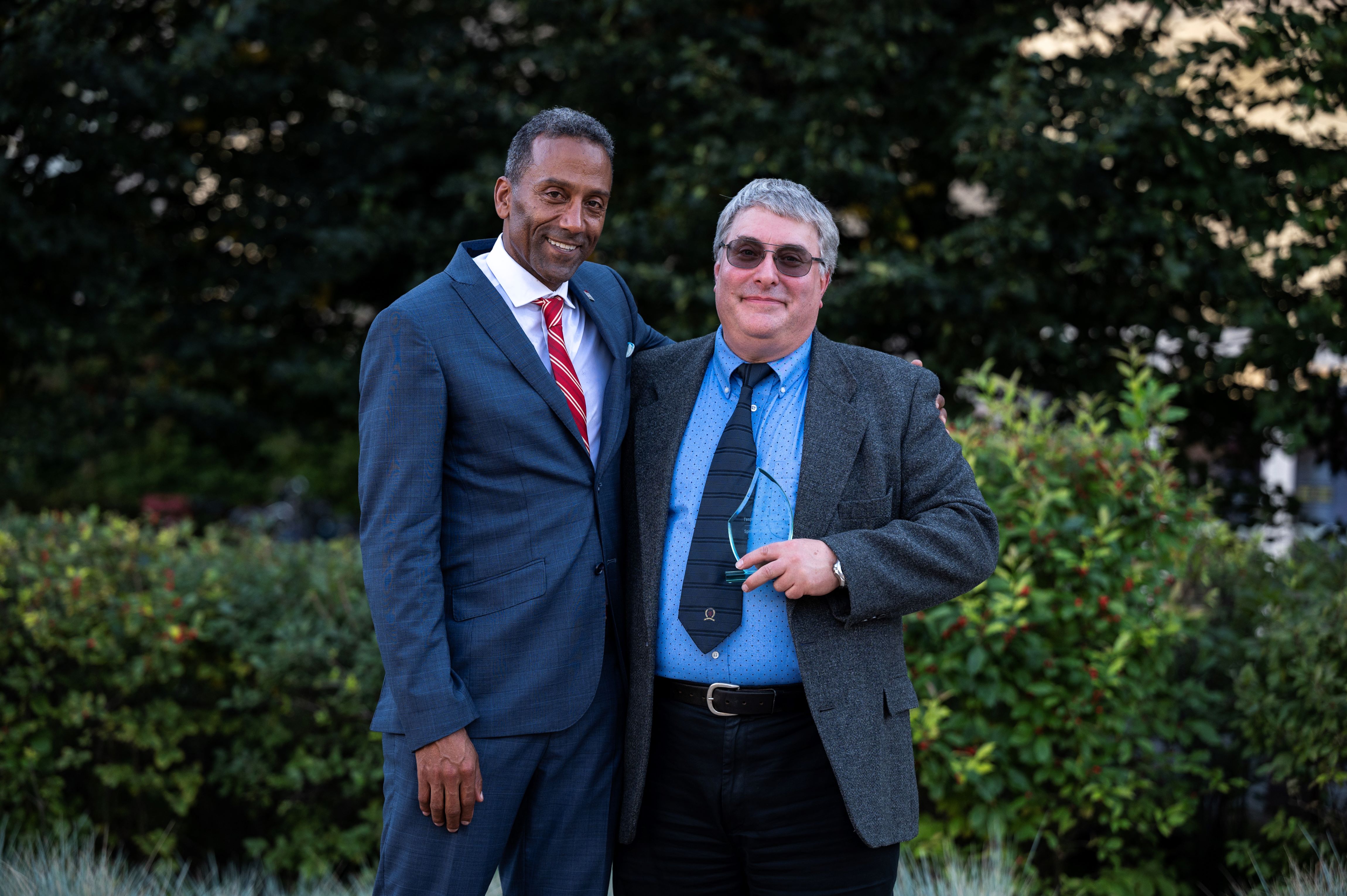 Marc Albert posing for a photo with Stéphane Brutus