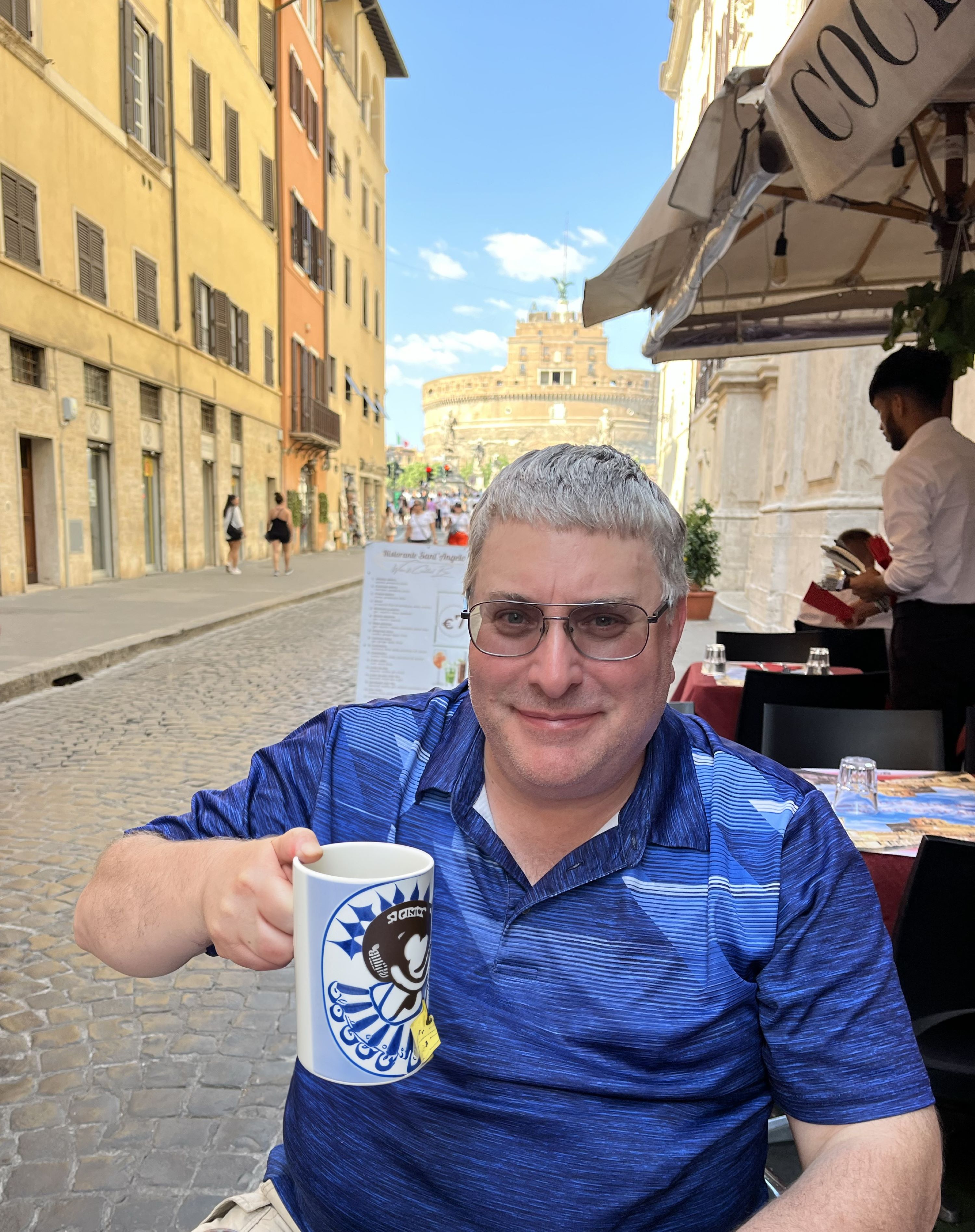 Marc Albert sitting at a restaurant drinking tea