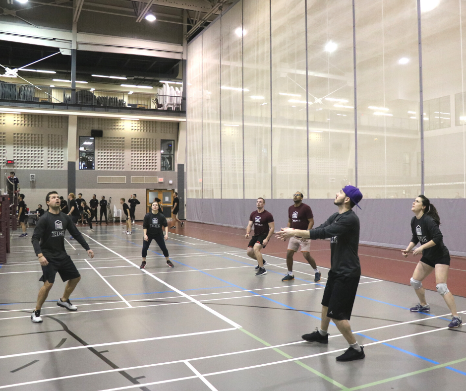 mba students playing volleyball on volleyball court